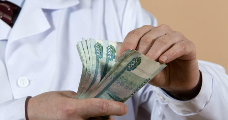 Medical worker with money in hand